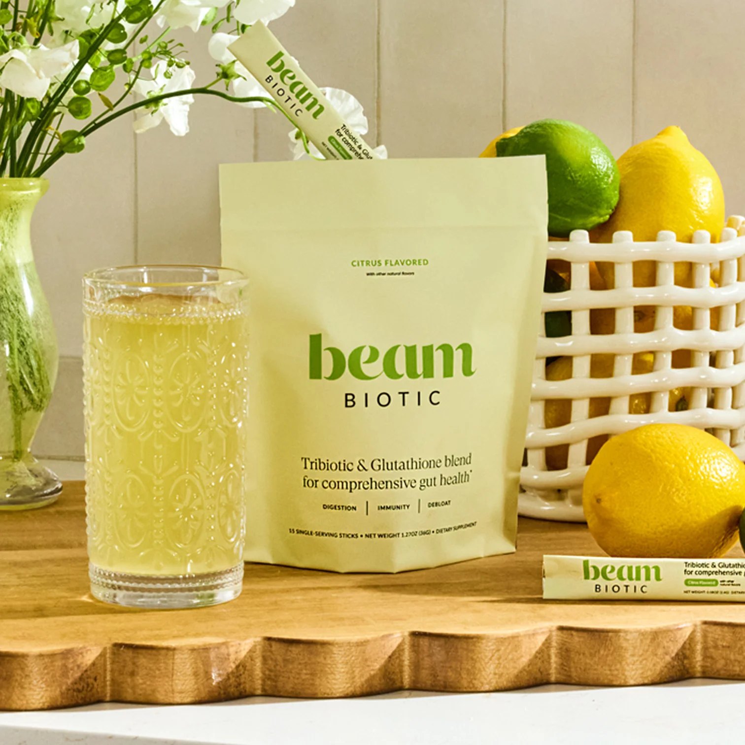 Beam Biotic pouch displayed with a poured glass and fresh citrus.