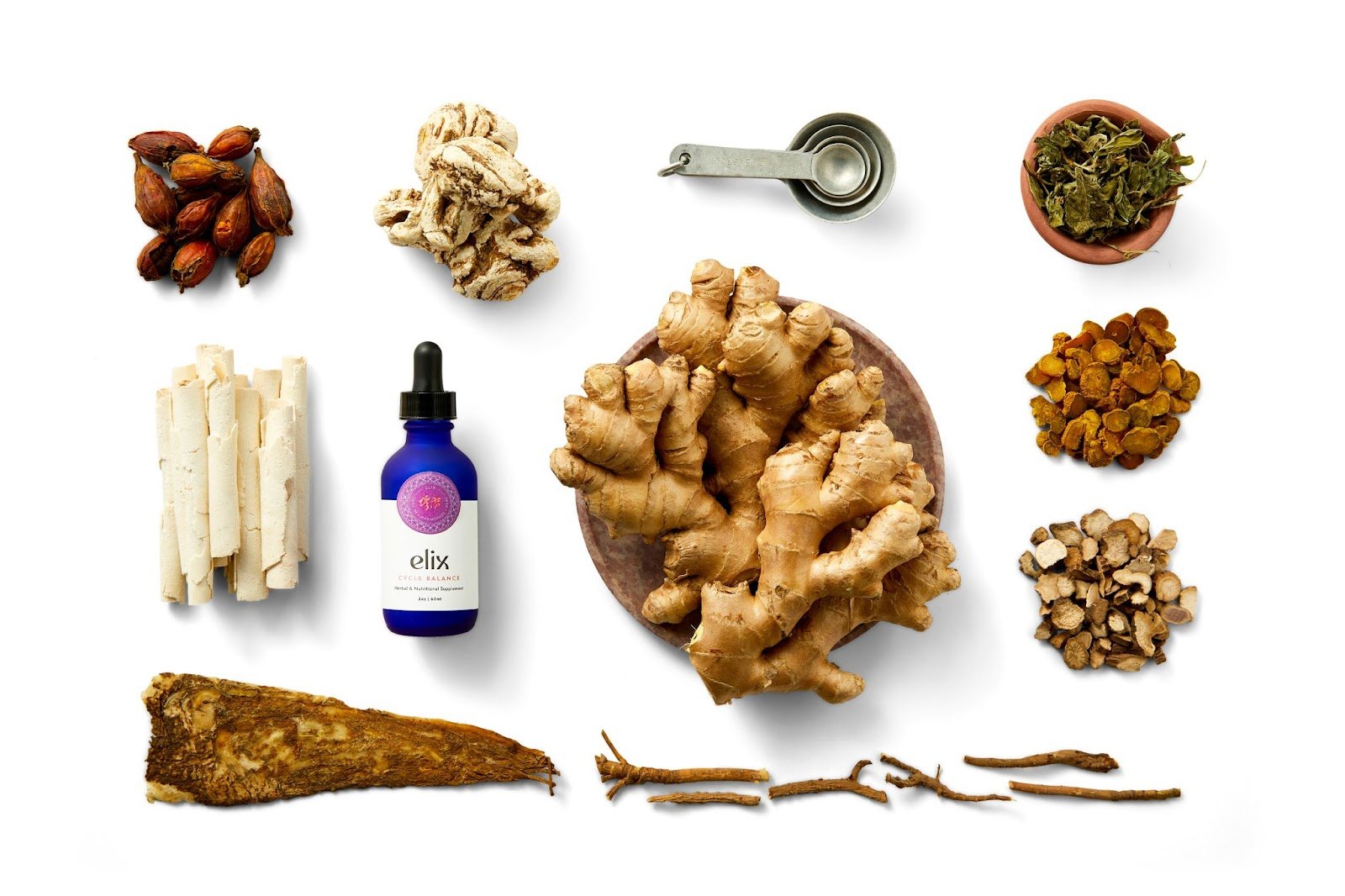 Elix Cycle Balance bottle surrounded by ginger roots and botanicals.