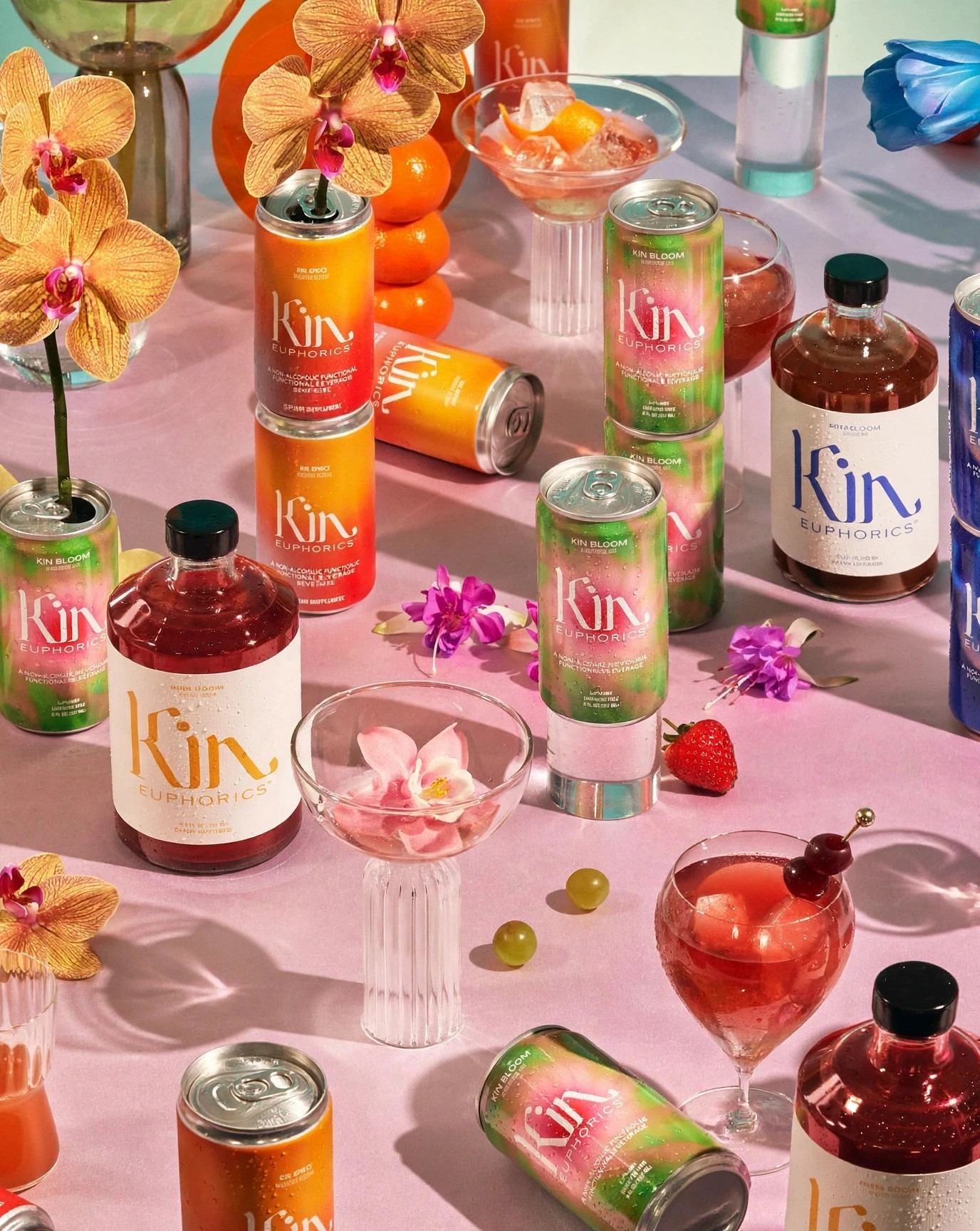 Kin cans and bottles styled with orchids and cocktails.
