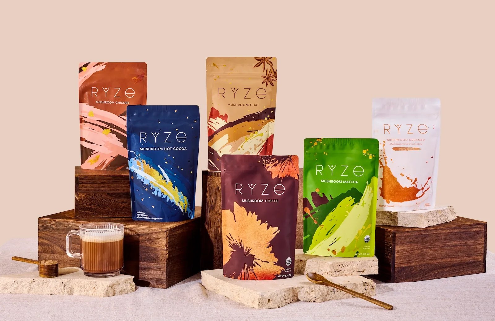 RYZE coffee cocoa matcha and creamer pouches arranged on blocks.